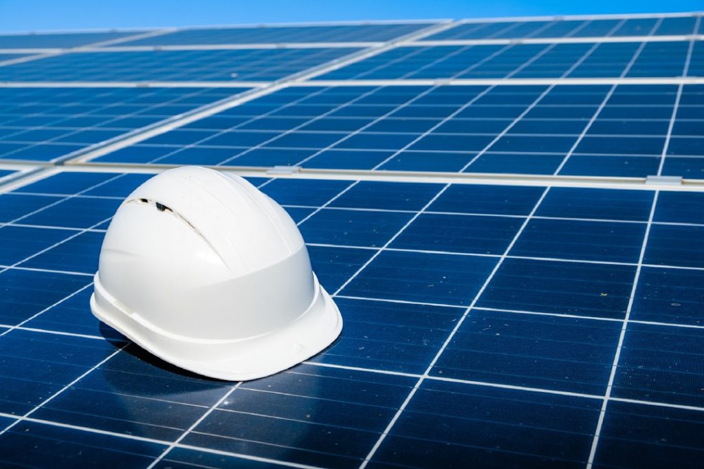 The Art of Drawing Readers In: Your attractive post title goes here Solar cell contractor document with orange engineering team helmet on solar cells panels. Renewable energy and ecology concept