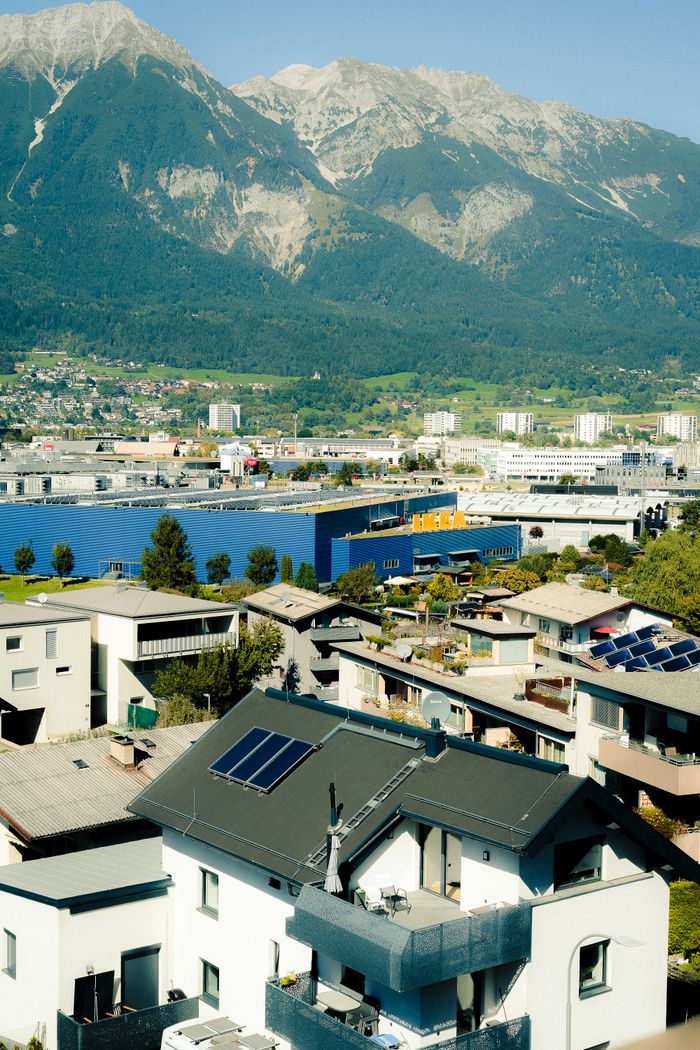 Stunning aerial view of Innsbruck, Austria, showcasing modern and traditional architecture against the majestic Alps.