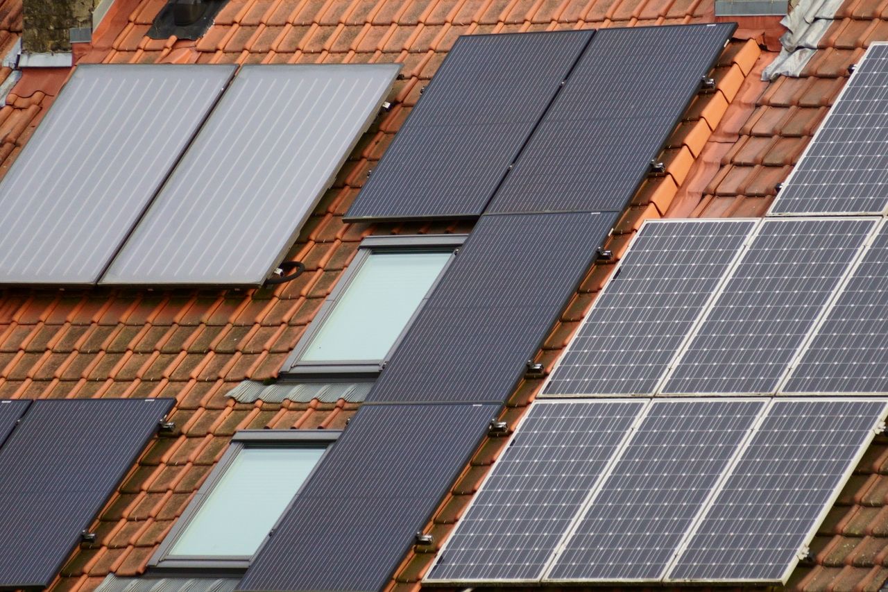 contact-img Close-up of solar panels on a tiled roof, showcasing sustainable energy solutions.